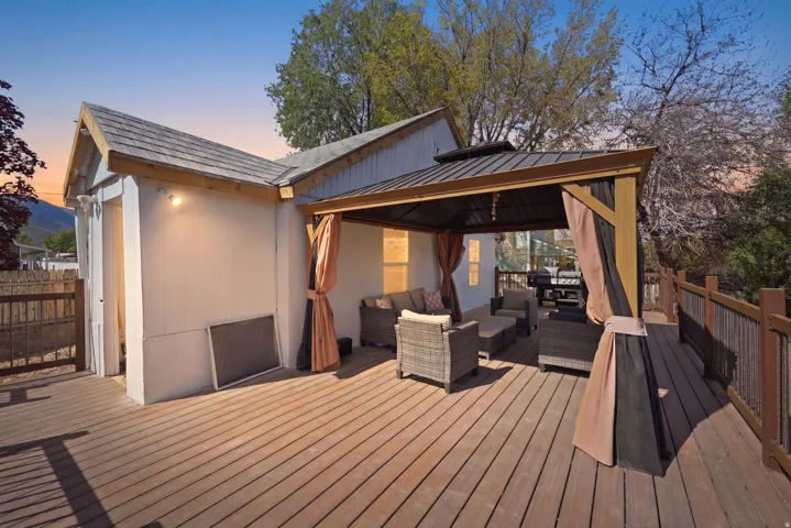Deck at dusk with an outdoor lounge area and a gazebo
