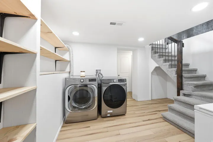 Laundry area featuring recessed lighting, light wood-style floors, and washing machine and clothes dryer