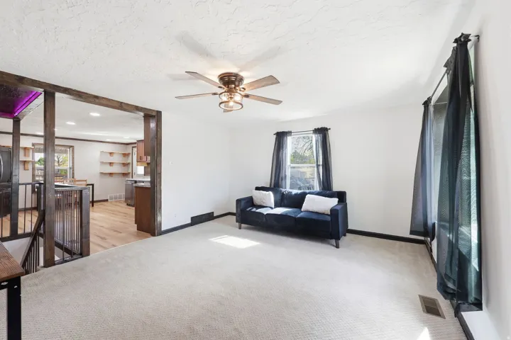 Sitting room featuring a ceiling fan, light carpet, an upstairs landing, a textured ceiling, and recessed lighting