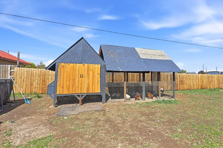View of chicken coop featuring a fenced backyard