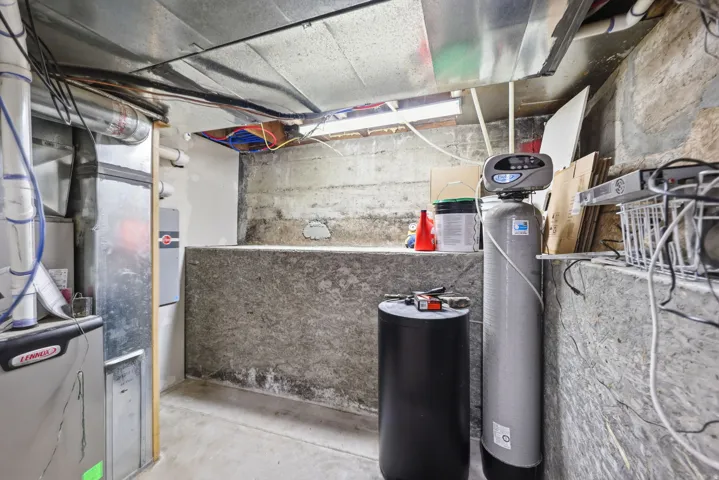 Utility room featuring heating unit