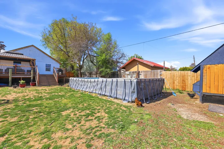 View of green lawn with a deck