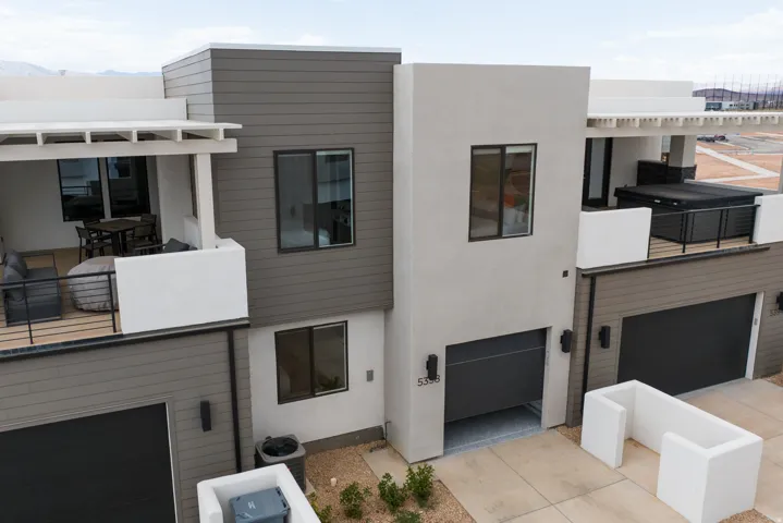 Modern multi-level exterior featuring horizontal siding and stucco finishes