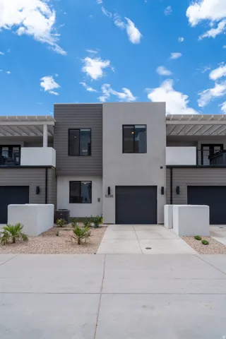 Contemporary townhome exterior featuring a modern facade with mixed siding and stucco finishes