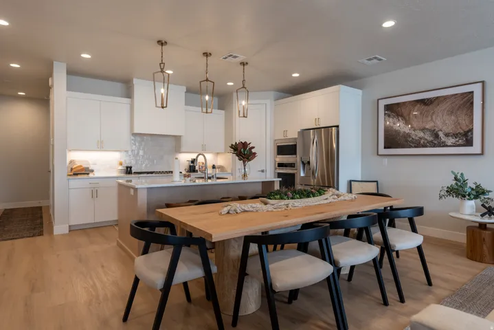 Open-concept kitchen and dining area with wood-finish flooring