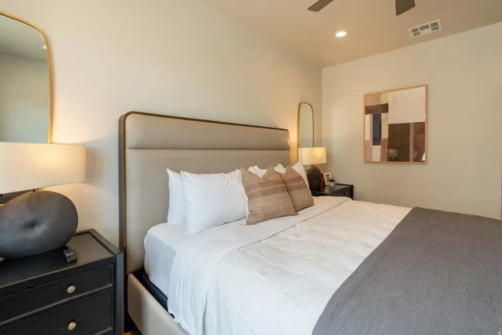 Upholstered headboard with an integrated frame, recessed lighting, and a ceiling fan