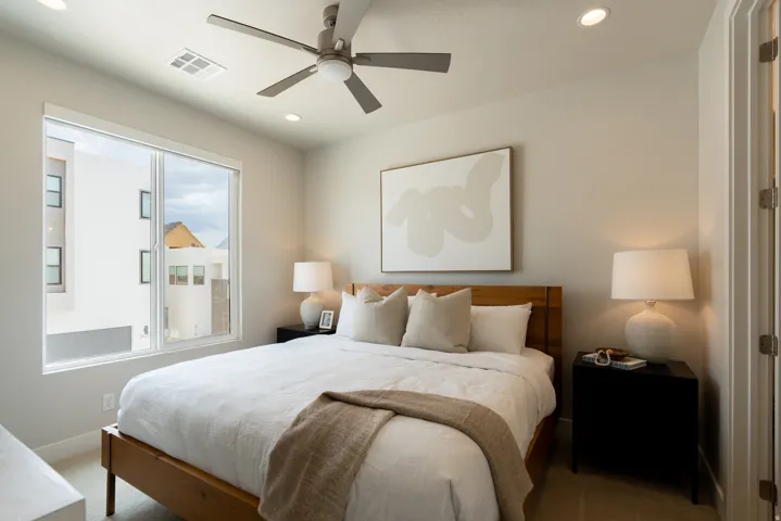 Spacious room featuring a large window, recessed lighting, and a ceiling fan