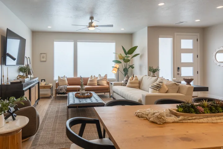 Open-concept living space featuring wood-finish flooring, recessed lighting, and a ceiling fan