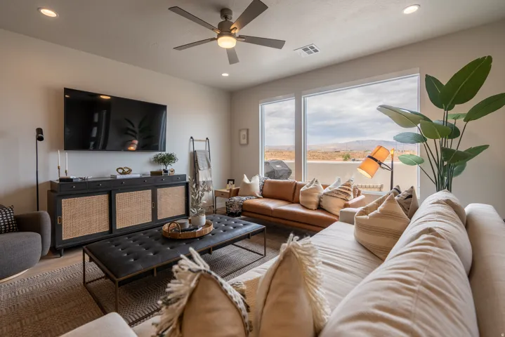 Living area featuring panoramic windows, recessed lighting, and a ceiling fan