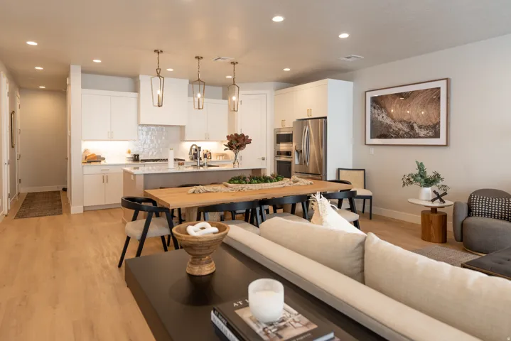 Open-concept living space featuring wood-finish flooring, recessed lighting, and a contemporary kitchen