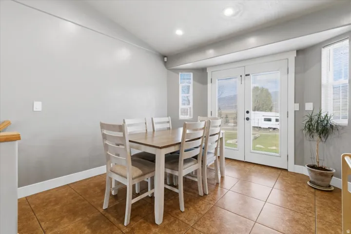 Dining area featuring ceramic tile flooring, light gray wall finishes, and white trim