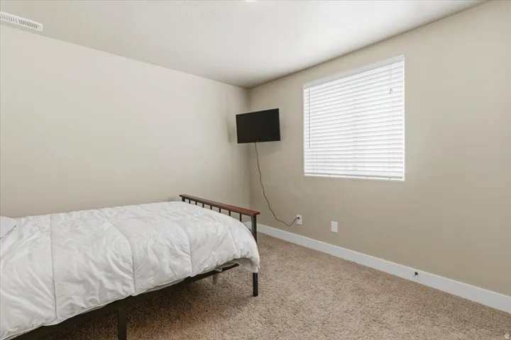 Warm neutral wall tones with white trim and carpeting