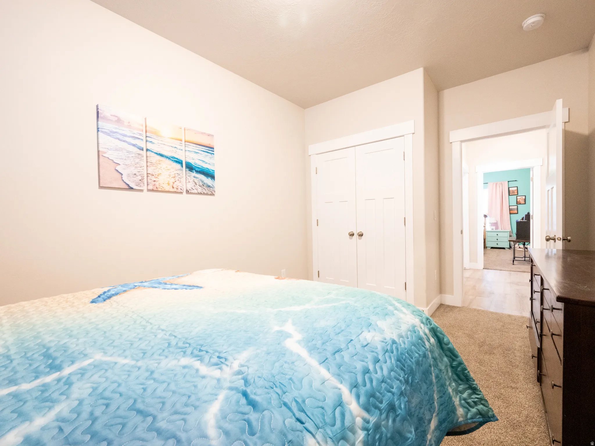 Neutral-toned walls complement plush carpet flooring