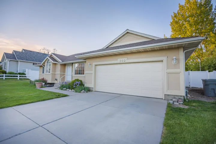 Single-story residence featuring a two-car garage, stucco exterior, and a concrete driveway