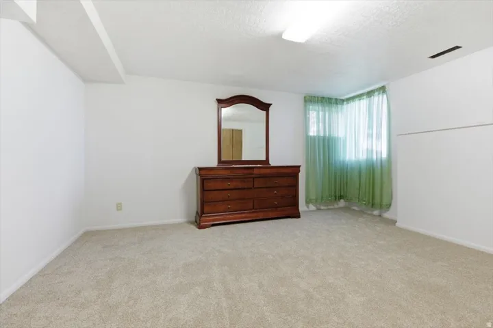 Carpeted room with white walls