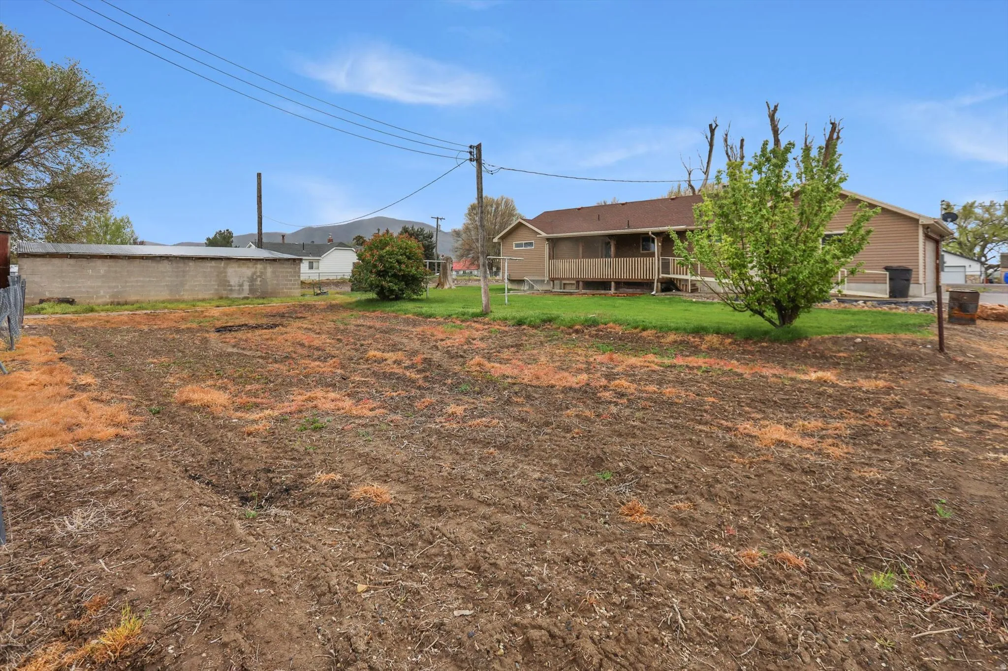 Expansive cleared lot with rich soil, offering significant potential for landscaping or future development