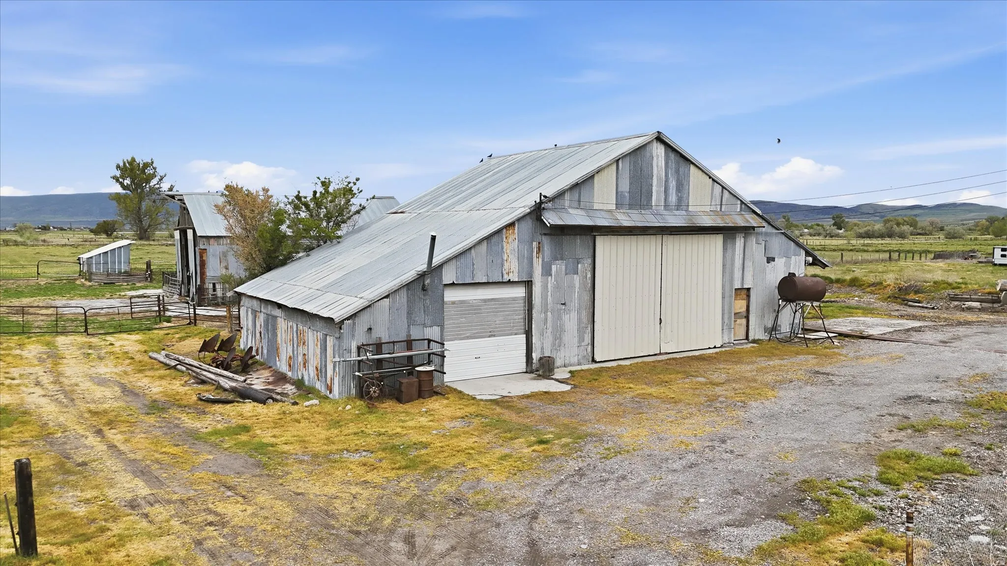 Large metal-sided barn with an expansive gravel pad