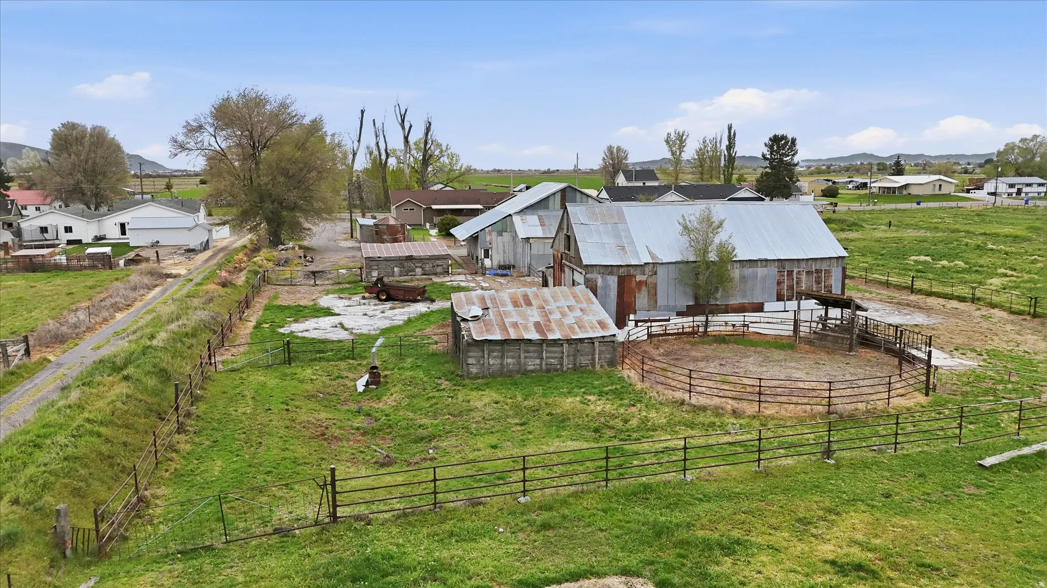 Expansive property featuring multiple outbuildings with corrugated metal roofs