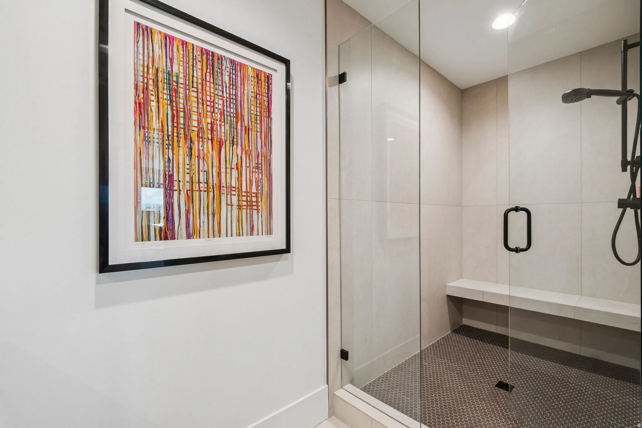 Second primary suite with large walk-in shower featuring a frameless glass enclosure,