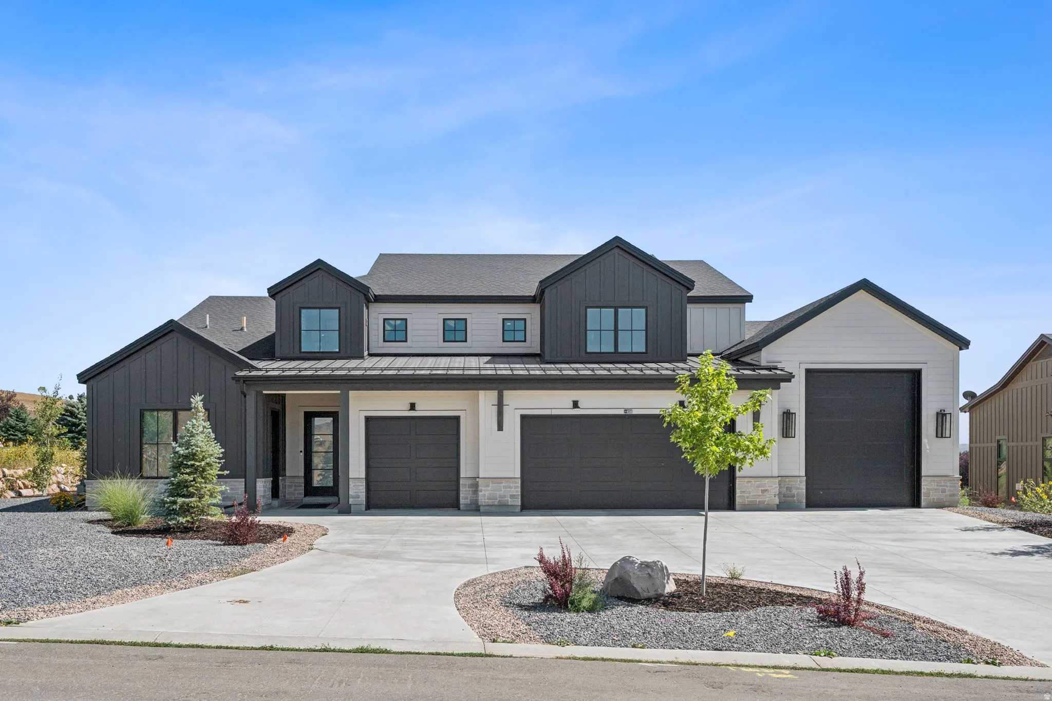 Modern farmhouse exterior with extra large 4-car garage with RV/boat parking.
