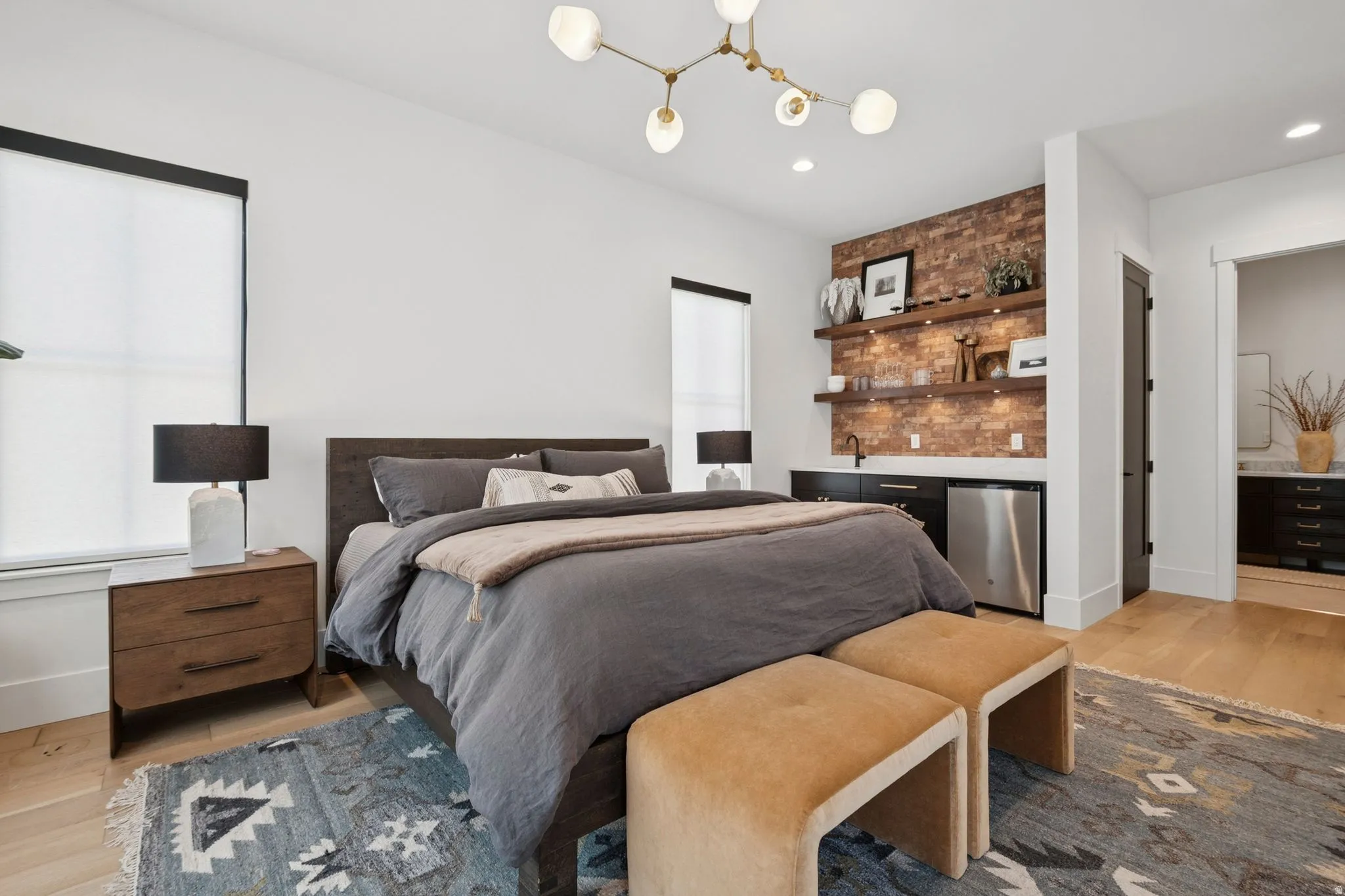 Lock-off Casita featuring a built-in wet bar with a stainless steel undercounter refrigerator, floating wood shelves, and a brick accent wall.