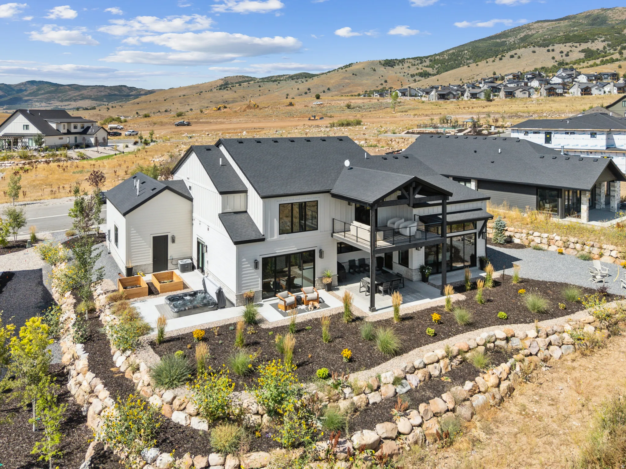 Contemporary exterior with grand windows and sliders facing golf course.