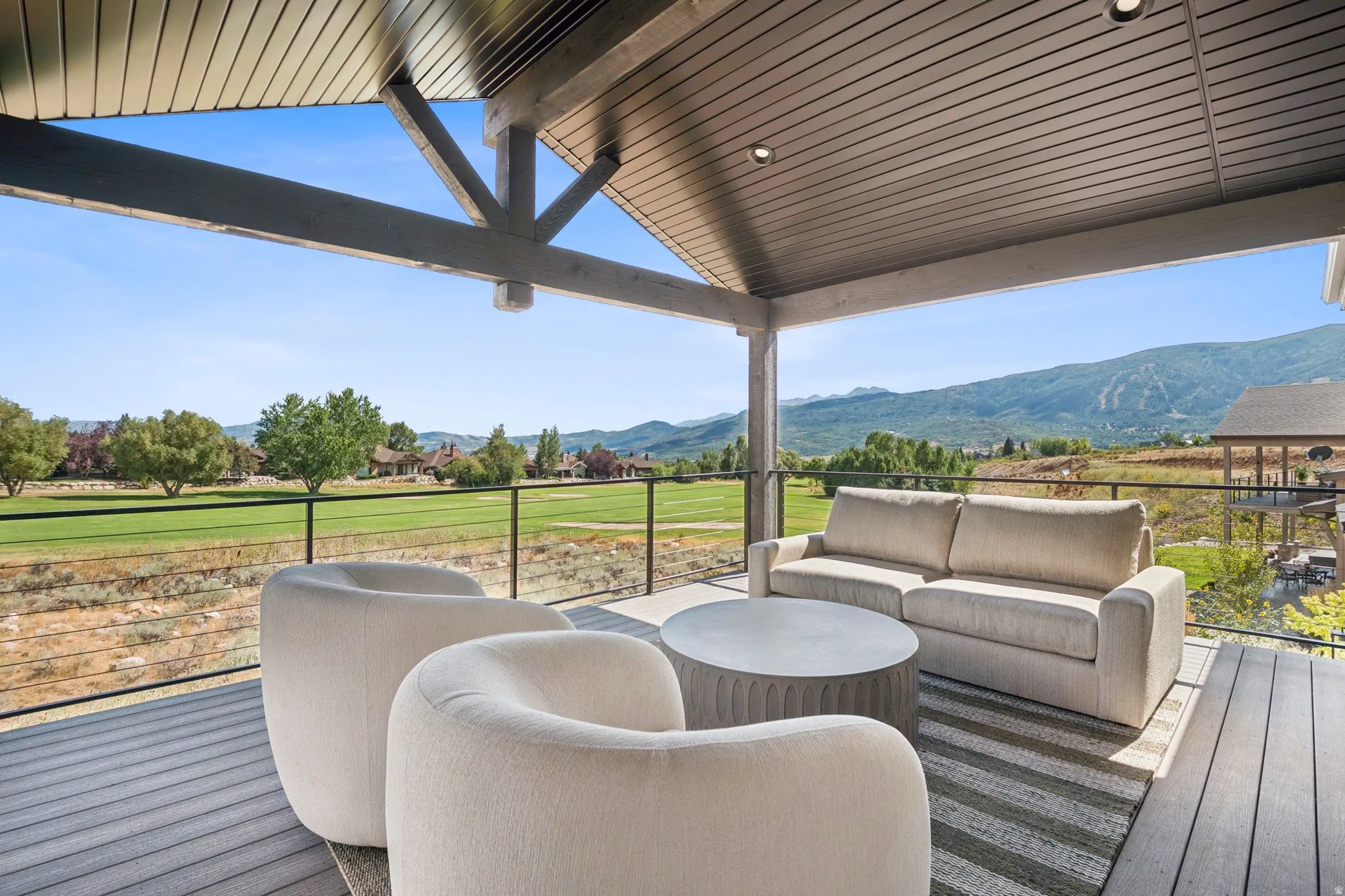Spacious covered deck overlooking golf course and the Wasatch range, Snowbasin, Nordic Valley,and Pineview Reservoir,