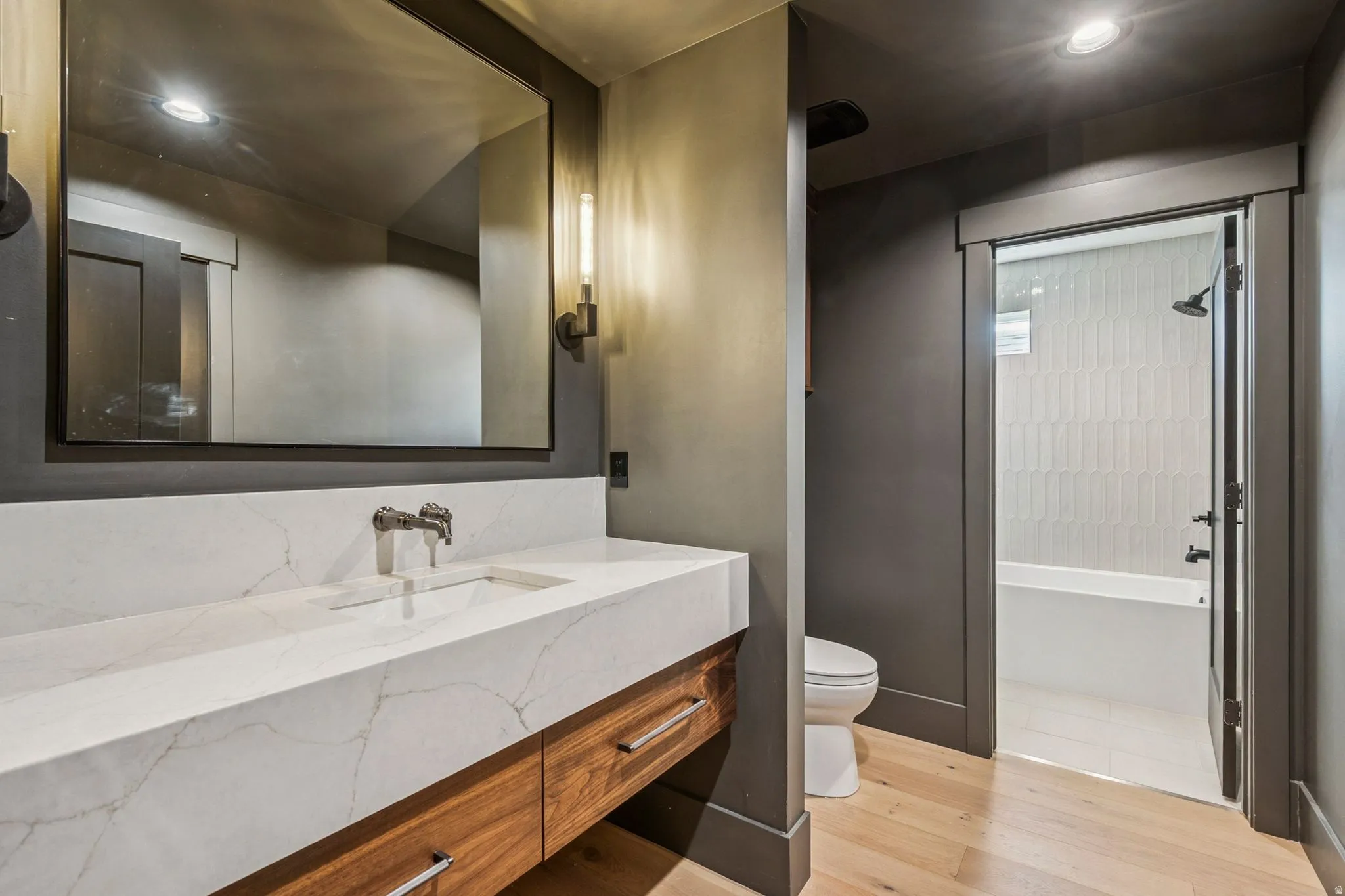 Modern bunk bath featuring a broad vanity and large soaking tub.