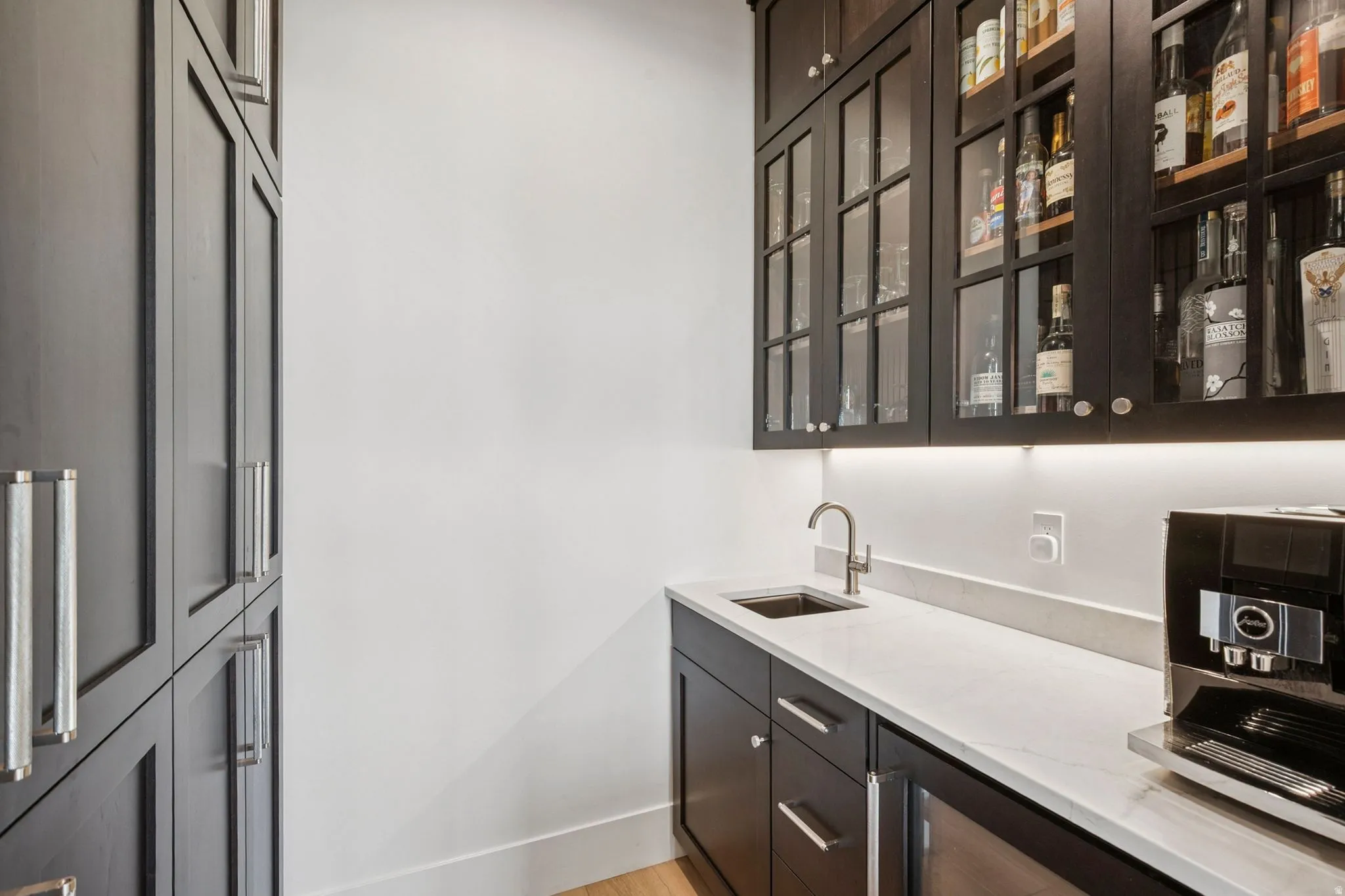 Custom wet bar/beverage station plus large pantry with pull-out shelves.