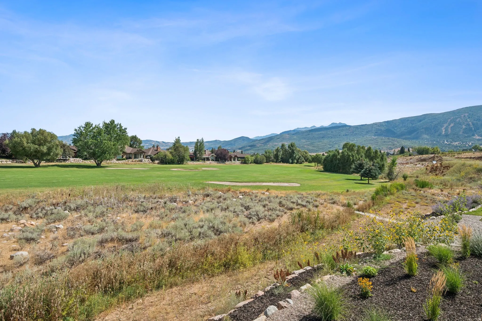 Expansive golf course frontage with views of the Wasatch range.