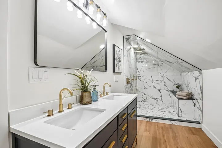 Dual vanity with integrated rectangular sinks and brass-finish fixtures
