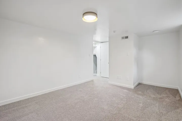 Neutral tone carpeting and white walls in this interior space
