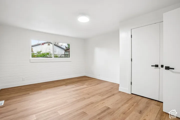 Light wood-finish flooring complements crisp white walls and modern trim