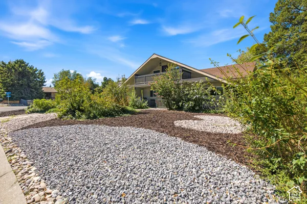 Layered landscaping featuring gravel and wood chip beds