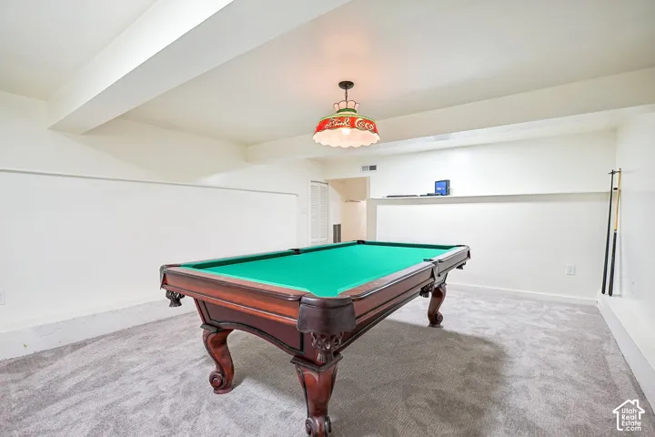 Finished room featuring recessed lighting, a built-in display shelf, and light gray carpeting