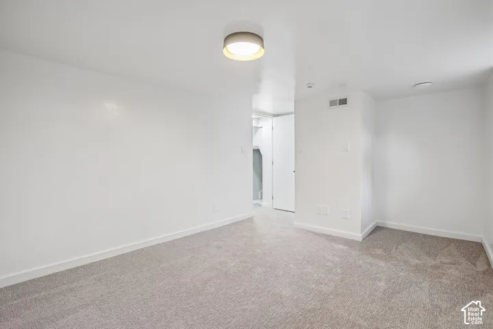 Neutral tone carpeting and white walls in this interior space