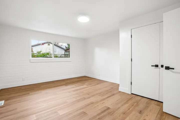 Light wood-finish flooring complements crisp white walls and modern trim