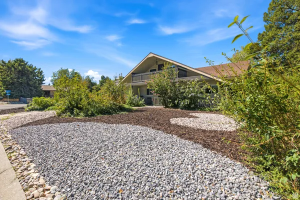 Layered landscaping featuring gravel and wood chip beds