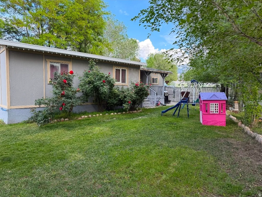 Expansive grassy backyard featuring mature trees