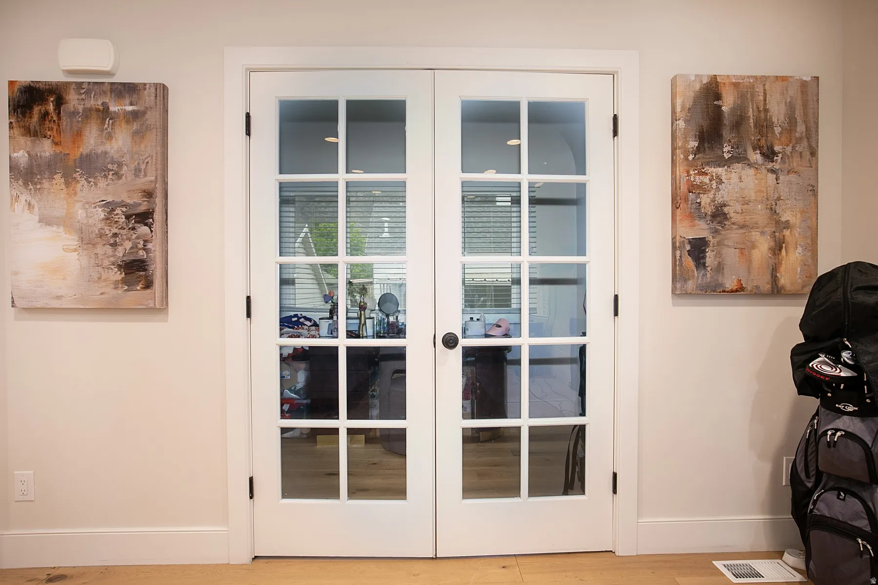 Detailed view of french doors and wood finished floors