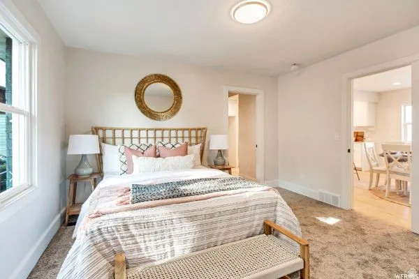 Carpeted room with a double-hung window, flush-mount ceiling light, and white baseboards