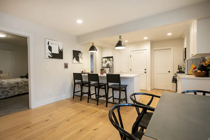 Dining space featuring light wood-style flooring, recessed lighting, and beam ceiling