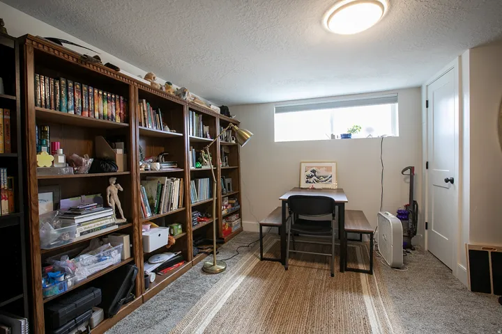Office with a textured ceiling and light colored carpet