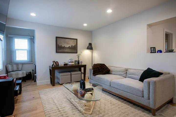 Living room featuring light wood finished floors and recessed lighting