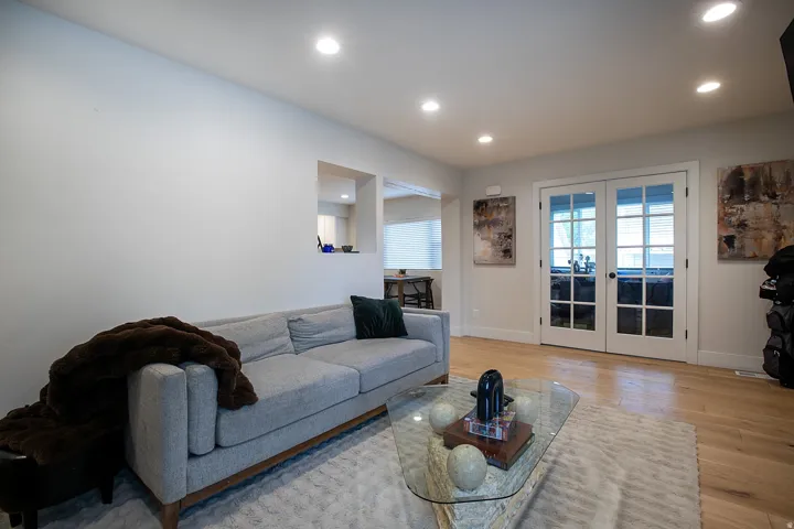 Living room featuring french doors, recessed lighting, and light wood-style floors