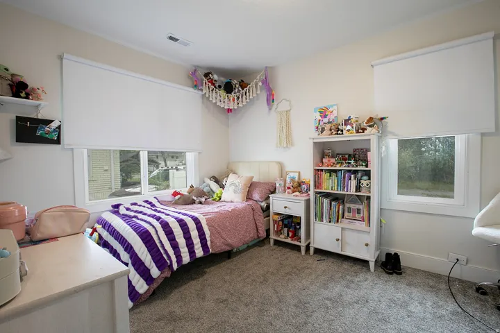 Bedroom featuring dark colored carpet