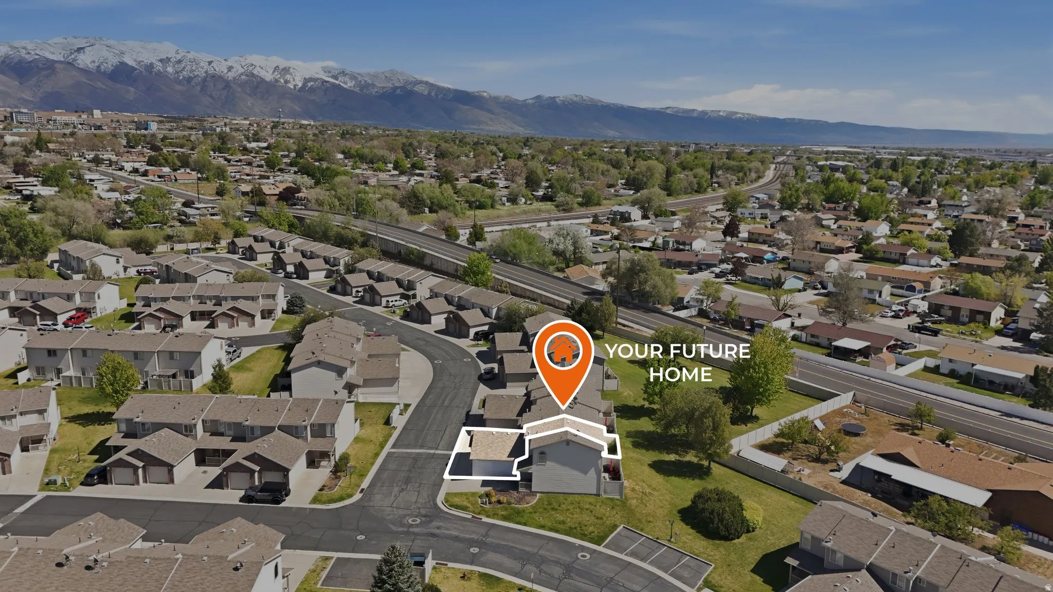 Aerial overview of property's location with nearby suburban area and mountains