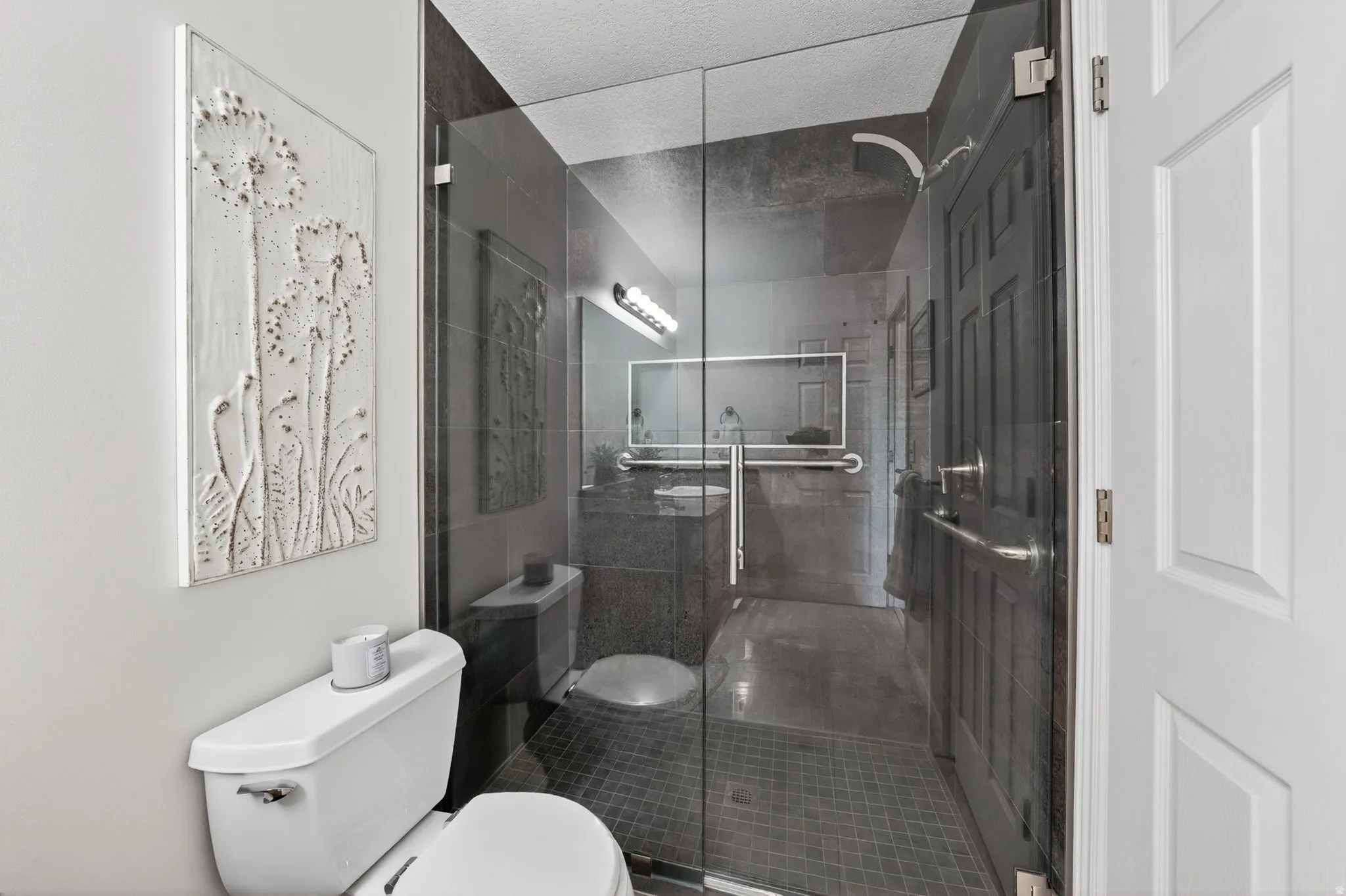 Bathroom featuring toilet and a stall shower