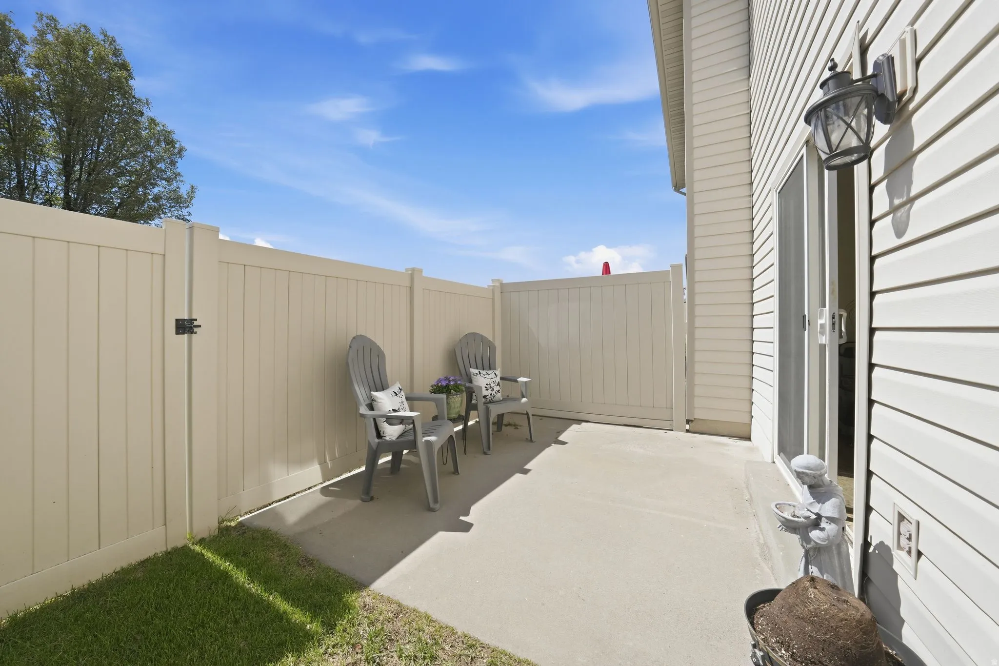 Fenced backyard with a patio area and a gate