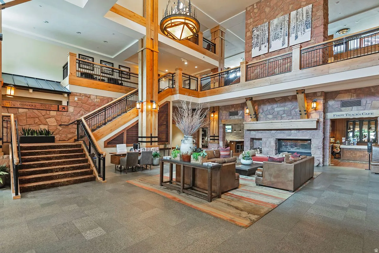 Spacious multi-level interior featuring stone and wood-beam construction